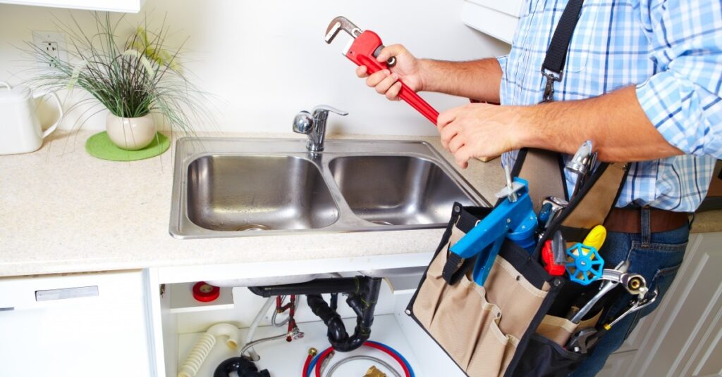 plumber working on sink