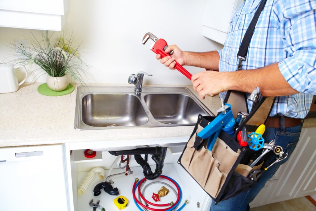plumber working on sink