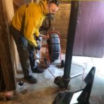 plumber feeding hose into pipe