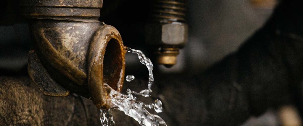 water coming out of a corroded pipe