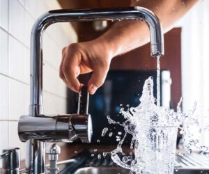 person turning on a faucet