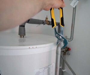 person fixing a water heater