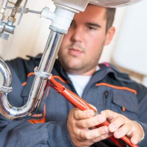 Plumber working on a sink.
