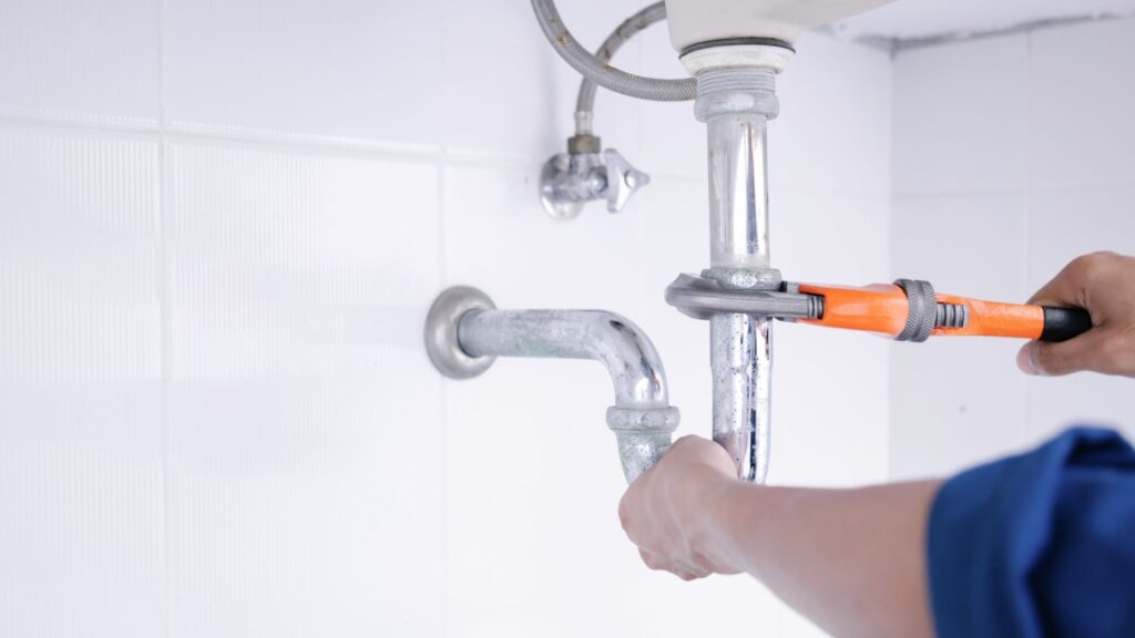 plumber fixing pipe
