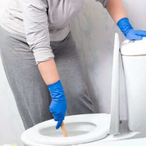 person working on toilet