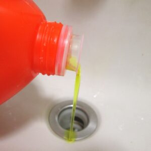 A chemical drain cleaner going down drain