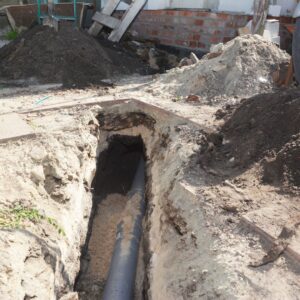 Image of a pipe once buried, being worked on