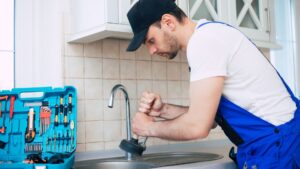 Man cleans sink drain