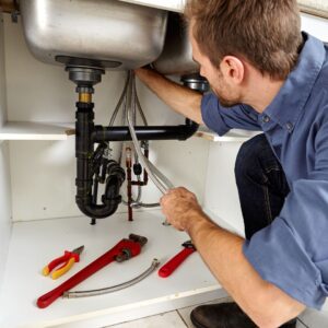 plumber fixing pipes
