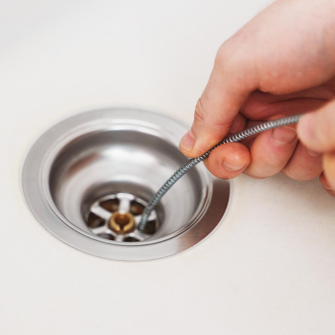 plumber inspecting a kitchen drain