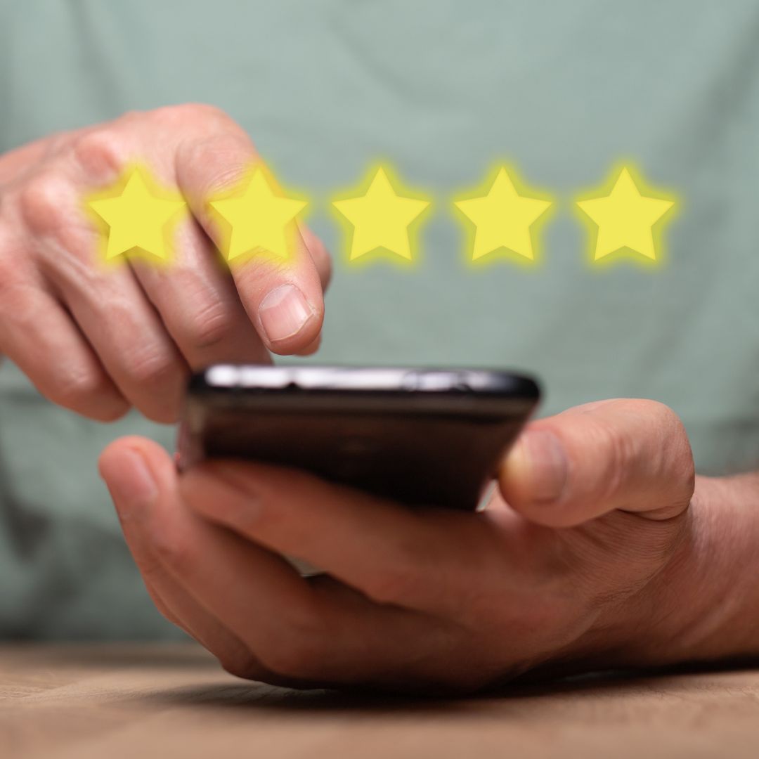 five stars floating over a person using a cellphone