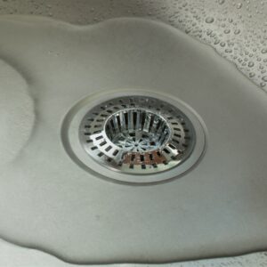 Water slowly going down a drain screen