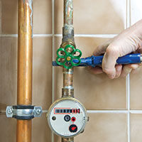 plumber working on pipes